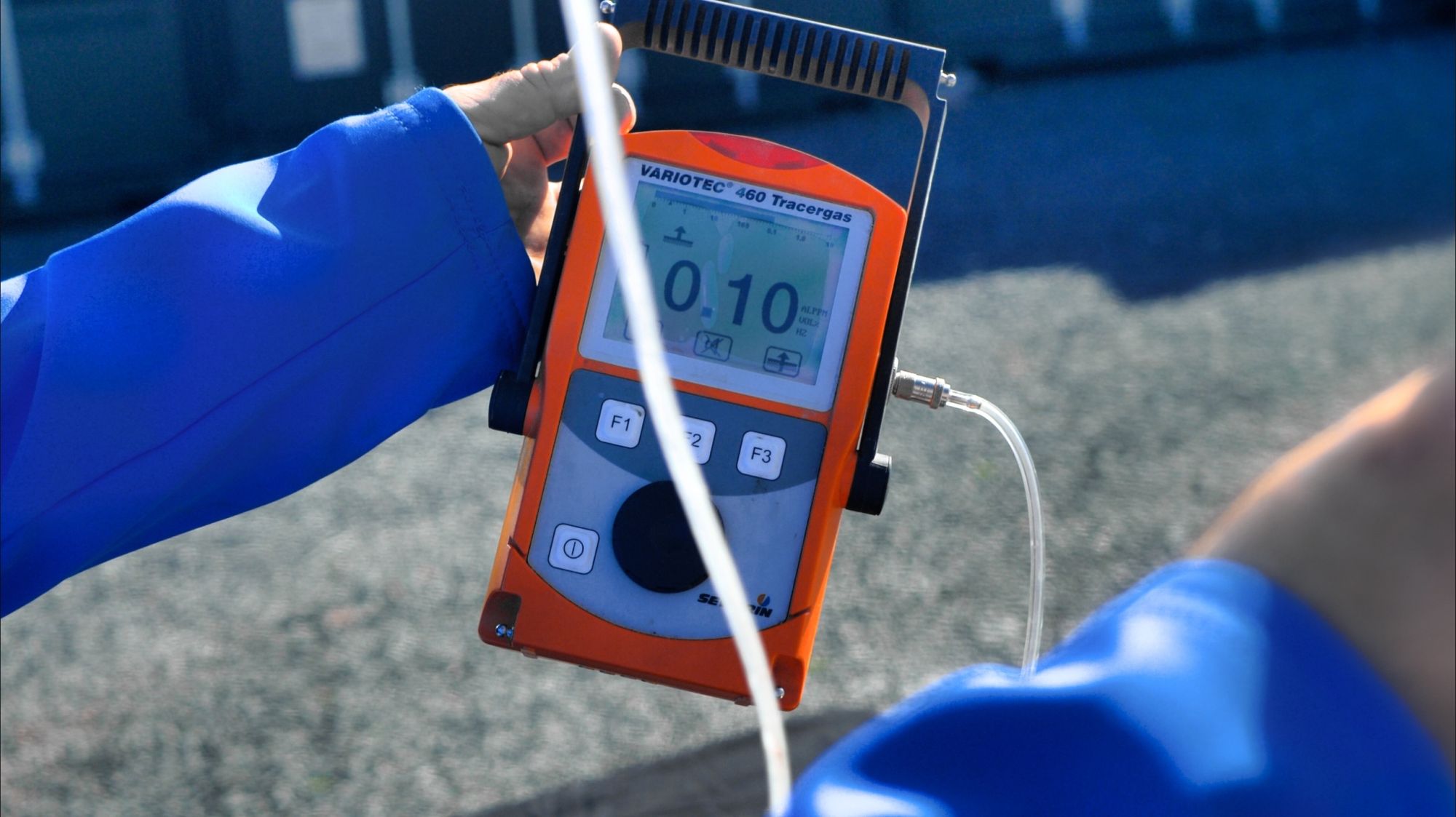 Specialist using tracer gas detection equipment